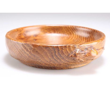 ROBERT THOMPSON OF KILBURN, A MOUSEMAN OAK NUT BOWL circular, the adzed exterior with small carved mouse signature. 15cm diam