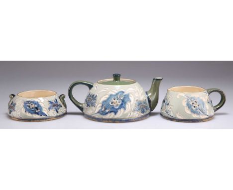 A JAMES MACINTYRE &amp; CO GESSO FAÏENCE TEA FOR ONE THREE-PIECE TEA SET probably designed by Harry Barnard, comprising a tea