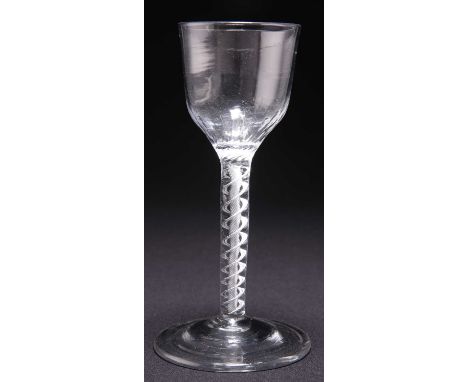 AN 18TH CENTURY AIR TWIST WINE GLASS the spiral fluted ogee bowl on a tape and corkscrew cable stem, above a conical foot. 15