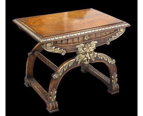 A RENAISSANCE STYLE PARCEL-GILT WALNUT STOOL OR TABLE the X-form frame carved with masks. 50.5cm high, 62cm wide, 44cm deepSo