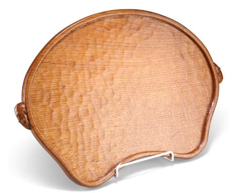 ROBERT THOMPSON OF KILBURN, A VINTAGE MOUSEMAN OAK TRAY kidney-shaped, with twin mouse handles, adzed. 47cm wide