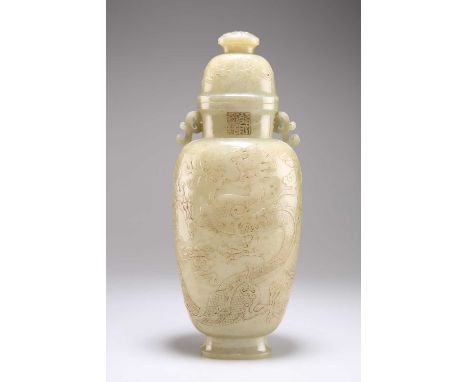 A CHINESE FAUX JADE VASE AND COVER decorated in low-relief with two dragons chasing a flaming pearl. 30cm high