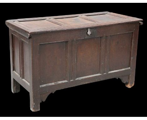 A LATE 17TH CENTURY OAK COFFER with three panel lid and front. 65.5cm high, 108.5cm wide, 50.5cm deep