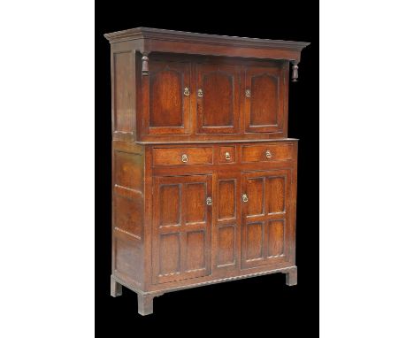 AN 18TH CENTURY OAK DEUDDARN, NORTH WALES with three pointed-arch panel doors over three drawers with a pair of four-panel do