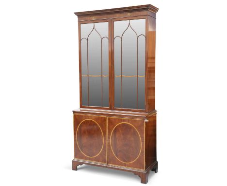 A GEORGE III STYLE INLAID MAHOGANY BOOKCASE CABINET the upper section with a pair of glazed doors enclosing three adjustable 