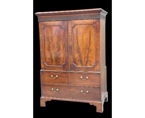 A GEORGE III MAHOGANY GENTLEMAN'S PRESS CUPBOARD with a pair of flame mahogany panelled doors and two short over one long dra