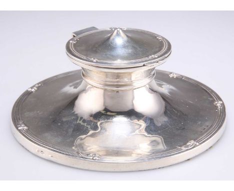 AN EDWARDIAN SILVER CAPSTAN INKWELL by Charles Boyton &amp; Son Ltd, Birmingham 1909, the hinged cover with conical dome, the