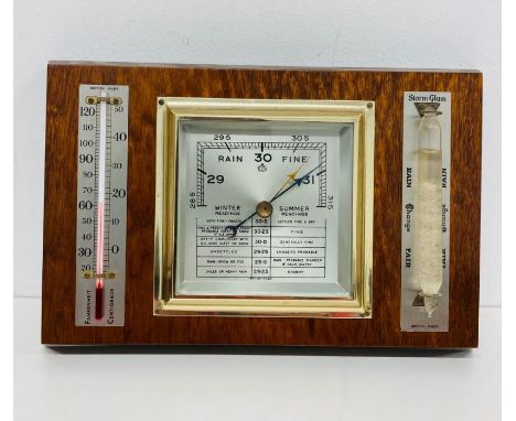A barometer, bearing the OC logo, set on a rectangular mount 