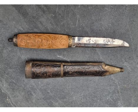 A vintage Scandinavian filching knife and sheath, with 9cm single edged blade and carved wooden handle, probably Norwegian.