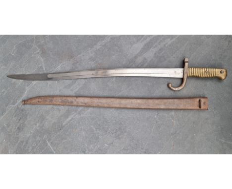 A French M1866 pattern chassepot&nbsp;sword bayonet and scabbard, the 57cm blade engraved 'St Etienne 1869' and No.29792, the