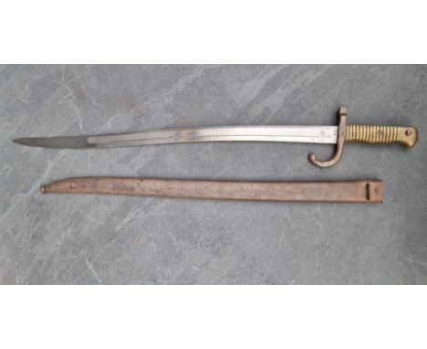 A French M1866 pattern chassepot&nbsp;sword bayonet and scabbard, the 57cm blade engraved 'St Etienne 1869' and No.29792, the