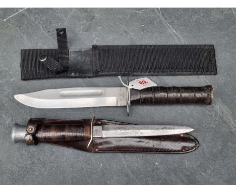 A combat knife, stamped 'US&nbsp; Japan', with&nbsp;17.5cm blade, in later scabbard; together with a Milbro 'Kampa' fighting 