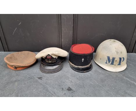 A vintage French Kepi; together with two other hats; and a helmet. (4)