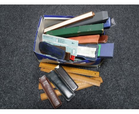 A box of large quantity of vintage slide rules and rulers 