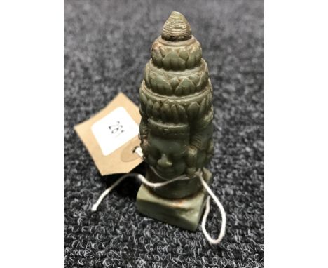 A jade finial depicting Brahmer the four headed god 