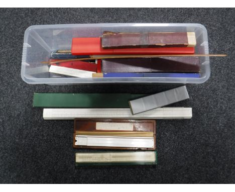 A box of large quantity of vintage slide rules and rulers 
