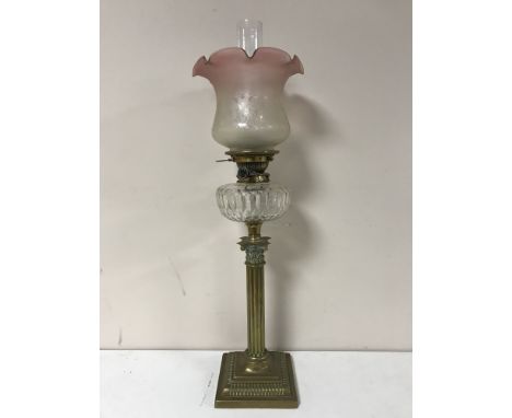 A Victorian glass oil lamp with clear glass reservoir CONDITION REPORT: Shade with numerous typical nicks to the lower rim. R