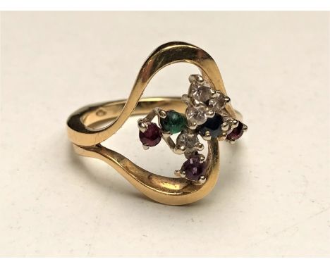 An 18ct gold multi stone ring, of wrythen form with diamonds, sapphire, emerald, amethyst, ruby and a garnet in raised claw s