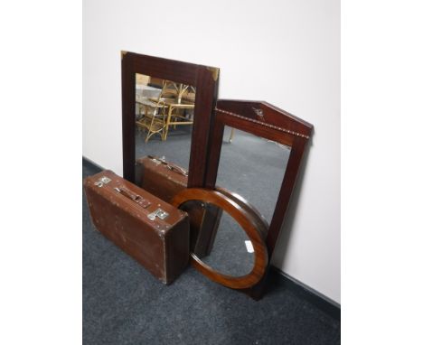 A vintage leather case, together with three mahogany wall mirrors 
