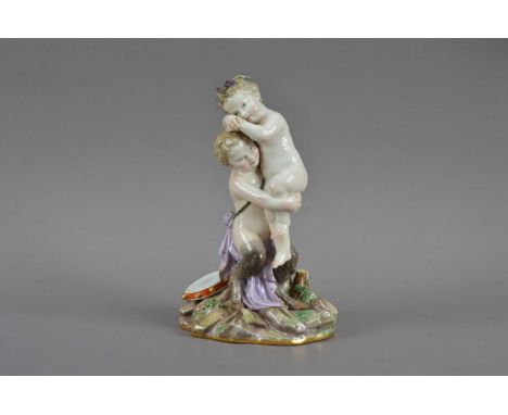 A 19th century Meissen seconds quality porcelain figurine of a cherub and satyr, the satyr carrying the cherub, a tambourine 