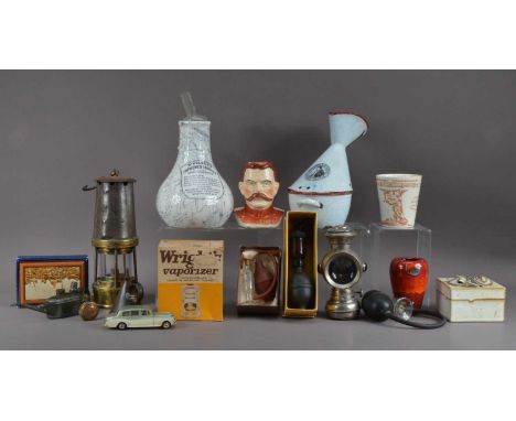 An assorted collection of works of art, including a miners lamp, 27cm high, an assortment of inhalers, some in cardboard reta