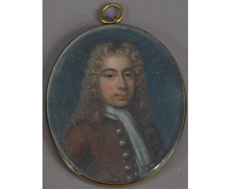 A 19th century or earlier Portrait miniature locket on ivory of a Georgian man, in a gilt metal oval frame, approx. size 7cm 