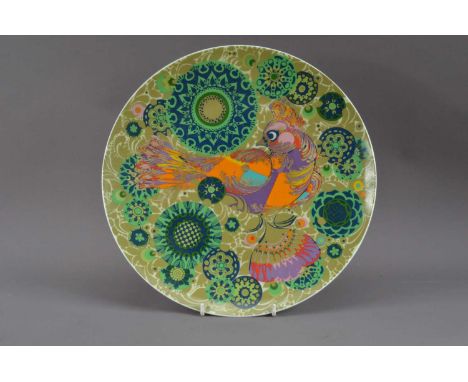 Byorn Winblad for Rosenthal, a porcelain wall mounted charger, a gilt bird in a swirling green background, 33cm diameter