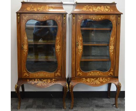 A pair of early 20th century continental mahogany display cabinets, with floral marquetry inlay, the tops with brass pierced 