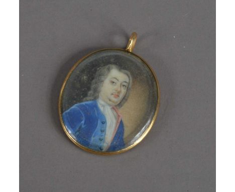 An 18th or early 19th century Portrait miniature locket on ivory of a man, with a grey wig and blue coat, in gilt metal case,