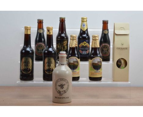 A collection of assorted vintage bottles of beer, including one boxed Courage example and a ceramic bottle of Brakespear (10)