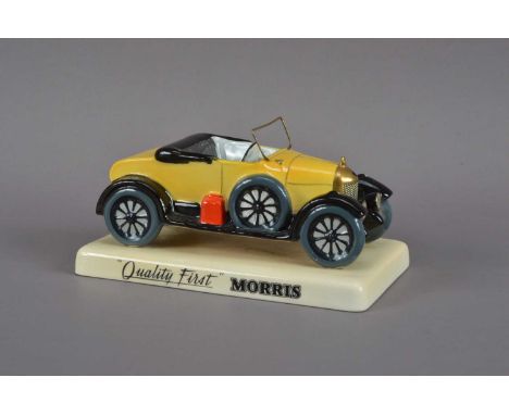A ceramic Carltonware Bull-nose Morris car, with a brass windscreen, on a rectangular base, marked to the underside 7cm H x 1