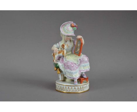 A Meissen porcelain figurine of a lady and a dog, the dog on her lap looking at a mirror (dogs tail AF), on a circular base w