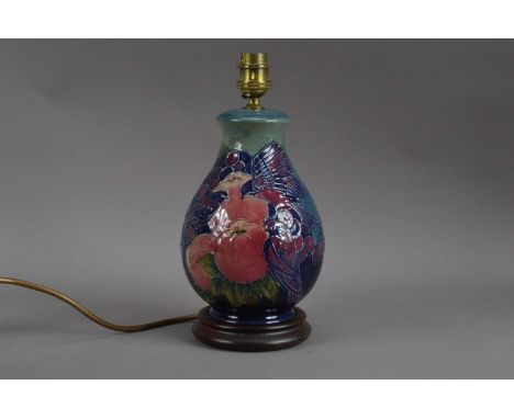 A Moorcroft pottery lamp, Pomegranate and finches pattern, 27cm highAppears in generally good condition, some crazing to the 