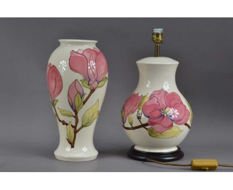 Two items of Moorcroft pottery, comprising a magnolia pattern table lamp, 35cm high and a Hibiscus vase, seconds quality, dat