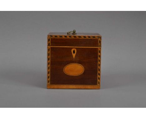An Edwardian mahogany and boxwood inlayed tea caddy, feather banded edges, the cover with a metal handle, currently locked, 1