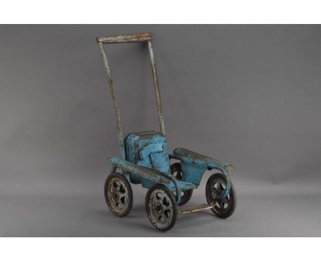 A first half 20th century metal painted dolls push chair, painted blue, rusted and weathered, on four wheels, 62cm high