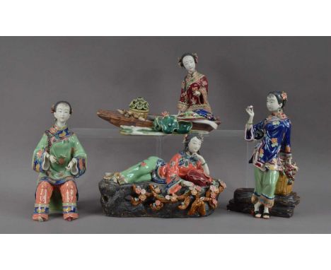 Four 20th century ceramic figures, all of women in differing poses, with unglazed hands and faces, the tallest 26cm H (4)One 