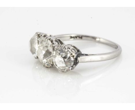 A platinum diamond three stone old oval cut mounted dress ring, each stone in claw setting, on pierced gallery mount, platinu