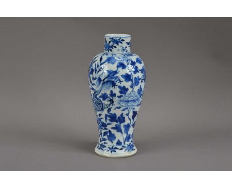 A Chinese porcelain blue and white vase, floral decoration with two dragons, four character mark to the underside, 22cm highS