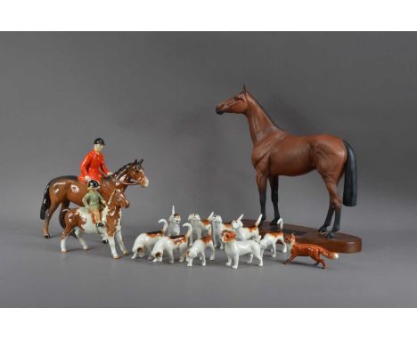 A Beswick horse, hound and fox ceramic set, comprising a hunt master on horseback, 21cm high, a child on a pony, nine hounds 