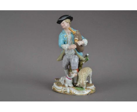 A Meissen porcelain figurine of a man playing the bagpipes, damage and losses to the bagpipes, hands and tree, with a dog an 