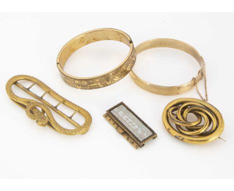 A late 19th early 20th century hinged gold plated bangle, with engraved floral design and a two pronged hidden clasp, 5.8 cm 