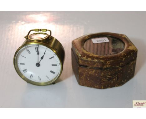 A brass drum cased carriage clock in fitted leather mounted case