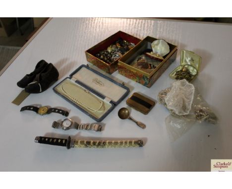 A pair of leather and iron mounted child's clogs; various costume jewellery; various watches and a paper knife in the form of