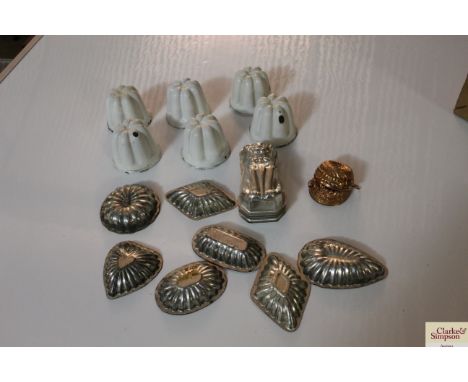 A collection of enamel and metal ware jelly moulds