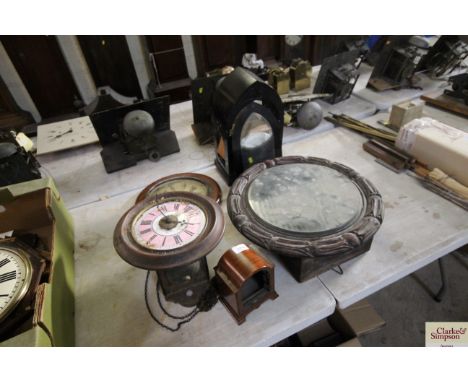 A Victorian postman's alarm, in need of restoration; a 19th Century carved mahogany clock case; an ebonised clock case etc. 