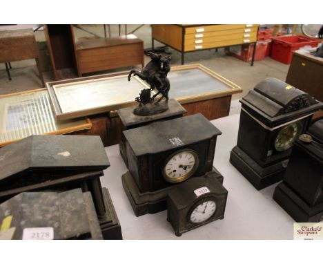 A Victorian marble cased mantel clock surmounted by a spelter figure of a warrior on horseback; a Victorian marble mantel clo
