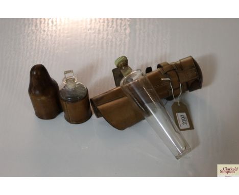 A leather cased glass flask, the stopper for Queen Anne Rare Scotch; and a leather cased glass medicine bottle 