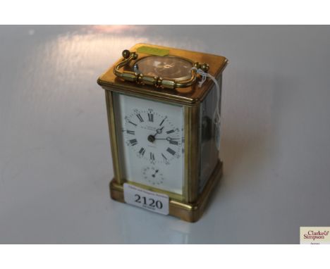 A late 19th Century brass cased carriage alarm clock by Chaudé Paris, white enamel Roman numeral dial
