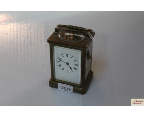 A late 19th Century brass cased carriage clock, white enamel Roman numeral dial